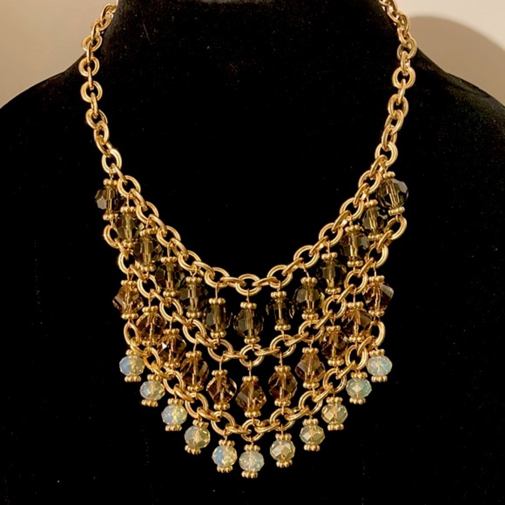 Gold costume jewelry with amber/white transluscent bib necklace.